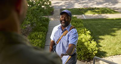 Postal worker delivering package