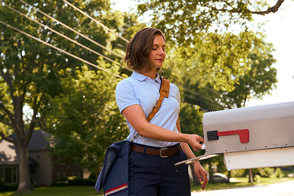 Postal employee delivering mail