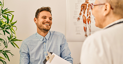 Doctor speaking to a smiling patient in office